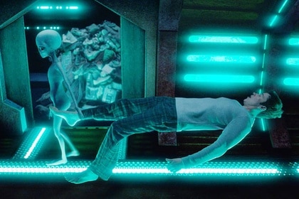 Mayor Ben Hawthorne (Levi Fiehler) floats next to a grey alien in a spaceship in Resident Alien Episode 302.