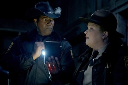 Sheriff Mike Thompson holds a flashlight next to Deputy Liv Baker in Resident Alien Episode 304.