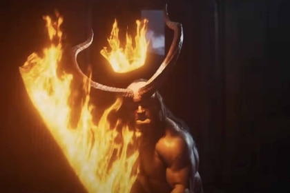 Hellboy (David Harbour) wields a fiery sword and crown in Hellboy (2019.