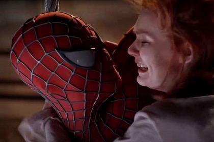 Spider-Man (Tobey Maguire) embraces a panicking Mary Jane Watson (Kirsten Dunst) in Spider-Man (2002).