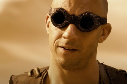 Riddick (Vin Diesel) wears dark goggles in Riddick (2013).