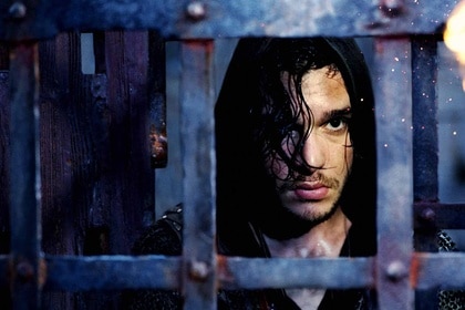 William Bradley (Kit Harington) looks through a caged dungeon door in Seventh Son (2014).