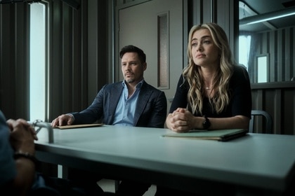 Oliver Odell (Nick Wechsler) and Rebecca 'Bex' Henderson (Melissa Roxburgh) talk to someone at a table on The Hunting Party Episode 108.