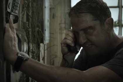 Brodie Torrance (Gerard Butler) speaks on a phone angrily in Plane (2023).
