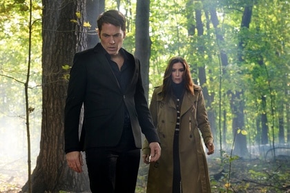 Luke Roman (Tim Rozon) and Susan Ireland (Sarah Levy) look down while walking in the woods on SurrealEstate Episode 305.