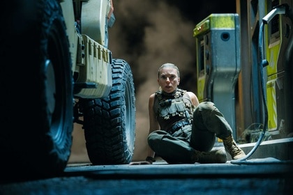 Zora Bennett on the floor next to a car in Jurassic World Rebirth (2025).