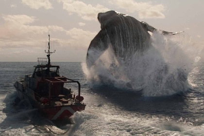 Mosasaurus jumps out of the ocean and over a ship in Jurassic World Rebirth (2025).