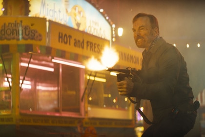 Bob Odenkirk as Hutch Mansell with a fire torch in Nobody 2.