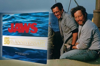 Quint (Robert Shaw), Martin Brody (Roy Scheider), and Matt Hooper (Richard Dreyfuss) pull on ropes and look out from a boat in Jaws (1975).