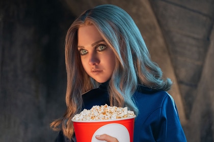 M3GAN from M3GAN 2.0 (2025) holds a popcorn bucket.