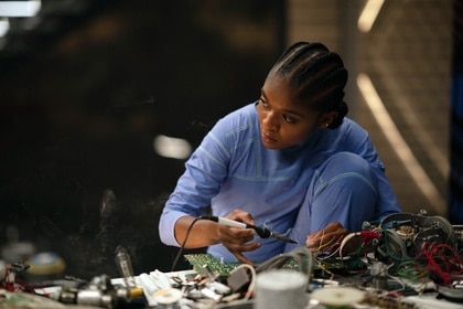 Ironheart (Dominique Thorne) sodders hardware in Black Panther: Wakanda Forever (2022).