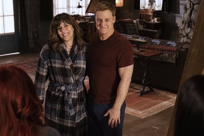 Heather (Edi Patterson) and Harry Vanderspiegle (Alan Tudyk) stand together and smile on Resident Alien Episode 404.