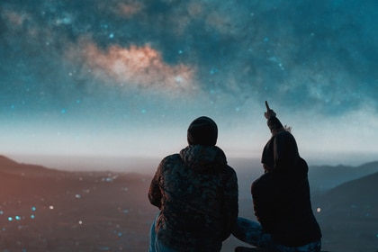 People stargazing at night.