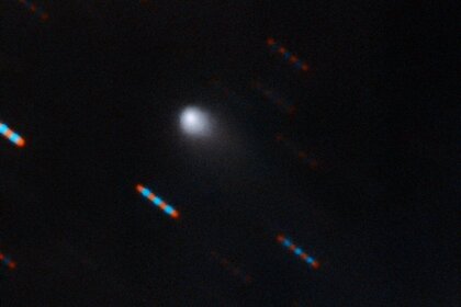 The interstellar comet 2I/Borisov imaged by the massive Gemini telescope on 9-10 September 2019. The telescope tracked the comet and took several images in red and blue filters, so the stars appear as a trail of multi-colored dots. 