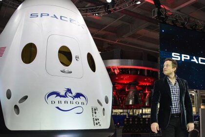 Elon Musk next to the recently unveiled SpaceX Dragon V2 capsule, designed for human flight. Credit: Robyn Beck/AFP/Getty Images