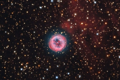 A deep color image of the planetary nebula NGC 6804 shows it to be a relatively standard example of its kind, but there are glowing red clouds near it whose origin is unclear. Credit: Adam Block/Mount Lemmon SkyCenter/University of Arizona