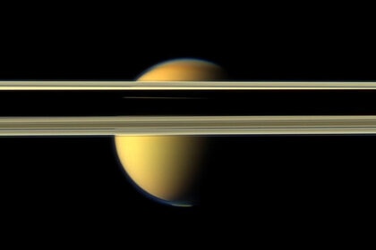 Titan tries to hide behind Saturn’s rings in this image from 2012. Note the visible bluish haze layer in Titan’s upper atmosphere. Credit: NASA/JPL-Caltech/SSI