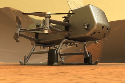 Artwork of the dual-quadcopter Dragonfly sitting on the surface of Saturn’s huge moon Titan. Credit: JHUAPL / Michael Carroll