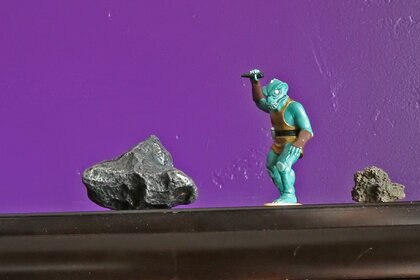 I couldn’t find a good picture of an asteroid, a dinosaur, and a volcano, so please instead enjoy this photo I took of a meteorite, a Gorn, and a piece of lava. Credit: Phil Plait (reluctantly)