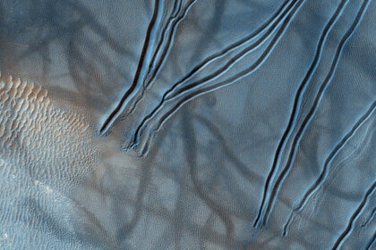 A color close-up image of gullies on Mars shows dimpling near their source, implying subsurface materials sublimating in the warmer seasonal weather. Credit: NASA/JPL/University of Arizona