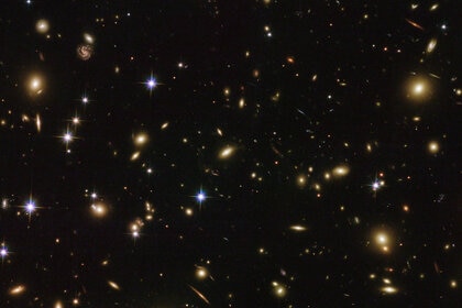 The immense galaxy cluster Abell 2163 is 2.5 billion light years away and contains hundreds of massive galaxies. Credit: ESA/Hubble & NASA
