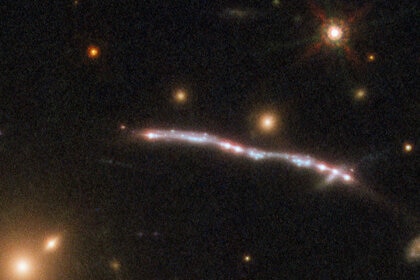 Detail of one Starburst Arc shows several bright knots; each is an image of the same region of the lensed galaxy replicated through the lensing process. Credit: ESA/Hubble, NASA, Rivera-Thorsen et al.
