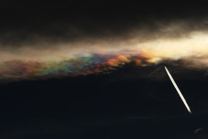 Contrast-enhanced view of iridescent lenticular clouds over Boulder, Colorado. Note the airplane. Credit: Phil Plait