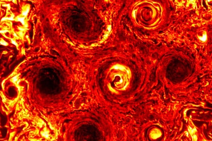 A thermal infrared image of Jupiter’s south pole in November 2019 reveals six cyclones surrounding a central cyclone; just two years before there were only five (the new one is to the lower right). Credit: NASA/JPL-Caltech/SwRI/ASI/INAF/JIRAM