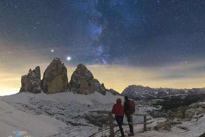 A couple, including the photographer, watch Jupiter and Saturn and the Milky Way over the Tre Cime di Lavaredo in the Italian Alps in early October 2020. Credit: Giorgia Hofer