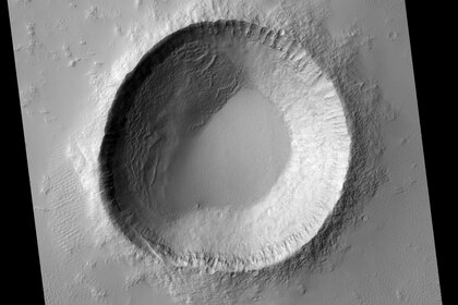 A spectacular if oddly shaped crater near the equator on Mars, situated between two ancient volcanoes. Credit: NASA/JPL/University of Arizona