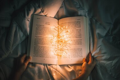 Person reading with book lights