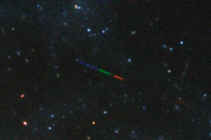 An image of the galaxy NGC 3981 has an interloper: An asteroid passing between us and it, streaked due to the long exposure and colored due to different filters being used. Credit: ESO