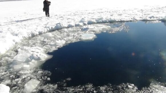 A hole in the frozen surface Lake Chebarkul made by the impact of a half-ton chunk of the Chelyabinsk meteorite on Feb. 15, 2013. We now have video of this event. Credit: ITAR-TASS Itar-Tass Photos/Newscom