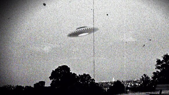 A black and white stylized photo of a UFO