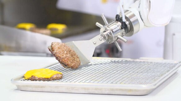 Flippy kitchen robot grilling hamburgers