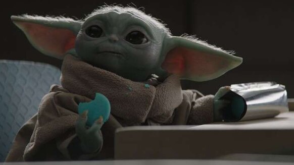 Baby Yoda eating blue cookie