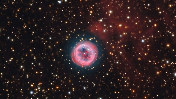 A deep color image of the planetary nebula NGC 6804 shows it to be a relatively standard example of its kind, but there are glowing red clouds near it whose origin is unclear. Credit: Adam Block/Mount Lemmon SkyCenter/University of Arizona