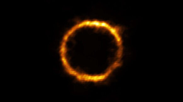 The ALMA image of the very distant galaxy SPT0418, distorted into a ring due to the gravity of an intervening galaxy. Credit: ALMA (ESO/NAOJ/NRAO), Rizzo et al.