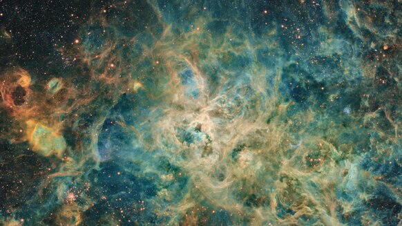 The Tarantula Nebula is a sprawling gas cloud in the Large Magellanic Cloud, and one of the largest star-forming regions in the local Universe. Credit: Jean Claude Canonne, Philippe Bernhard, Didier Chaplain, Nicolas Outters, and Laurent Bourgon