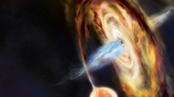 Artwork of a black hole as it tears a star apart, creating a whirling accretion disk of material around it, and blasts out huge beams of matter wound up by its magnetic field. Credit: Aurore Simonnet and NASA’s Goddard Space Flight Center