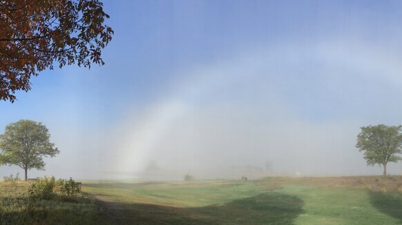 A fogbow created by the tiny droplets of water in a fog with strong sunlight behind the observer. Credit: Phil Plait