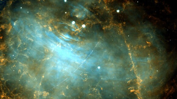 As Hubble observed the Crab Nebula supernova remnant, a small main-belt asteroid photobombed the image, leaving behind a curved streak due to Hubble’s orbital motion around the Earth. Credit: ESA/Hubble & NASA, M. Thévenot (@AstroMelina); CC BY 4.0