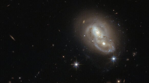 The galaxies collectively known as IRAS 06076-2139 are weakly interacting, but they’ve had an exciting past. Credit: ESA/Hubble & NASA