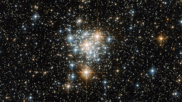 The Sun may have been born in an open cluster, a loose collection of stars that has since dissipated, scattering the stars. This image shows NGC 299, an open cluster in a satellite galaxy to our Milky Way. Credit: ESA/Hubble & NASA