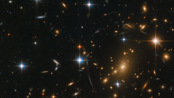 The gigantic galaxy cluster RXC J0142.9+4438 contains several hundred galaxies, and was observed by Hubble to study even more distant background galaxies whose light was amplified by the gravity of the cluster. Credit: ESA/Hubble & NASA, RELICS