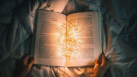 Person reading with book lights