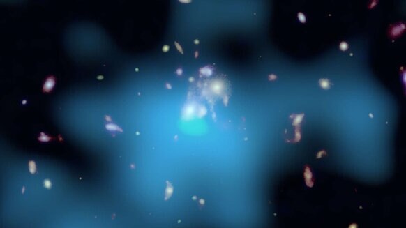An optical (Hubble) and X-ray (Chandra, blue) image of the galaxy cluster SpARC 1049 shows the galaxies in the cluster center. Stars are forming at a furious rate right in the center of this image. Credit: X-ray: NASA/CXO/Univ. of Montreal/J. Hlavacek-Lar