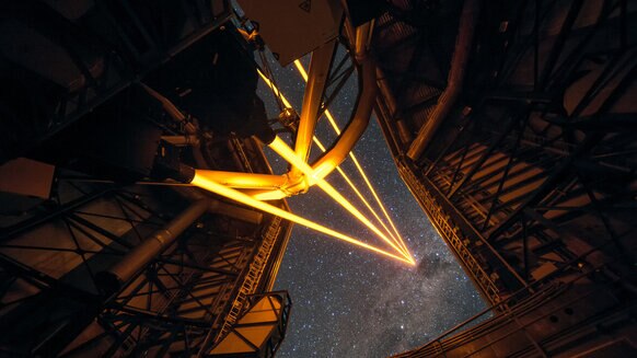 Four lasers beam into the sky to help sharpen images taken using the Very Large Telescope. Credit: ESO/F. Kamphues
