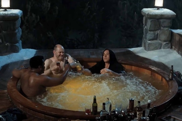 Nick Webber (Craig Robinson), Lou Dorchen (Rob Corddry), and Adam (John Cusack) cheers beers while sitting in a hot tub in Hot Tub Time Machine (2010).