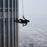 A cable-suspended Ethan Hunt (Tom Cruise) runs on the side of the building in Mission: Impossible – Ghost Protocol (2011).